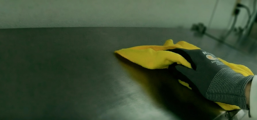 Technician wiping surfaces after antimicrobial fogging service